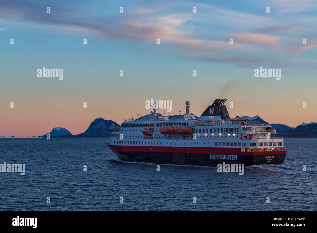 Hurtigruten Nordlys cruiseship cruise ship in the early morning glow of sunrise at Norway, Scandinavia, Europe in October Stock Photo