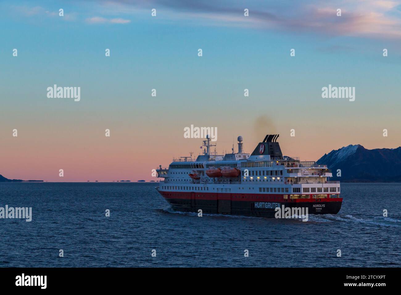 Hurtigruten Nordlys cruiseship cruise ship in the early morning glow of sunrise at Norway, Scandinavia, Europe in October Stock Photo