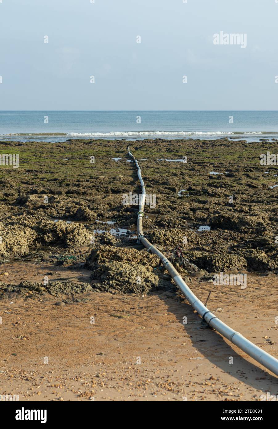 Dirty sewage from the pipe which flows into the sea, environmental pollution Stock Photo