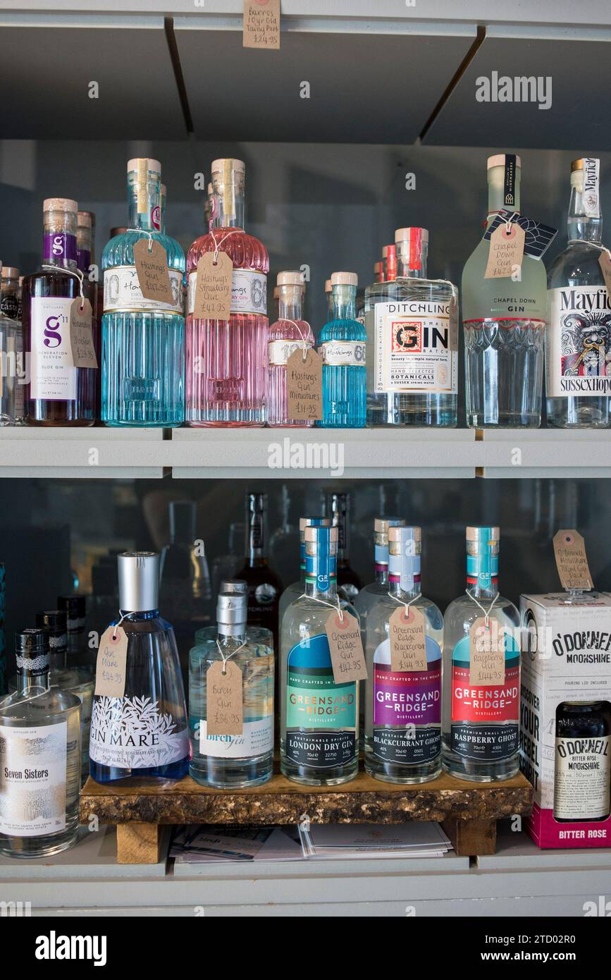Shelves with high end bottles of wine and gin on display for sale in a