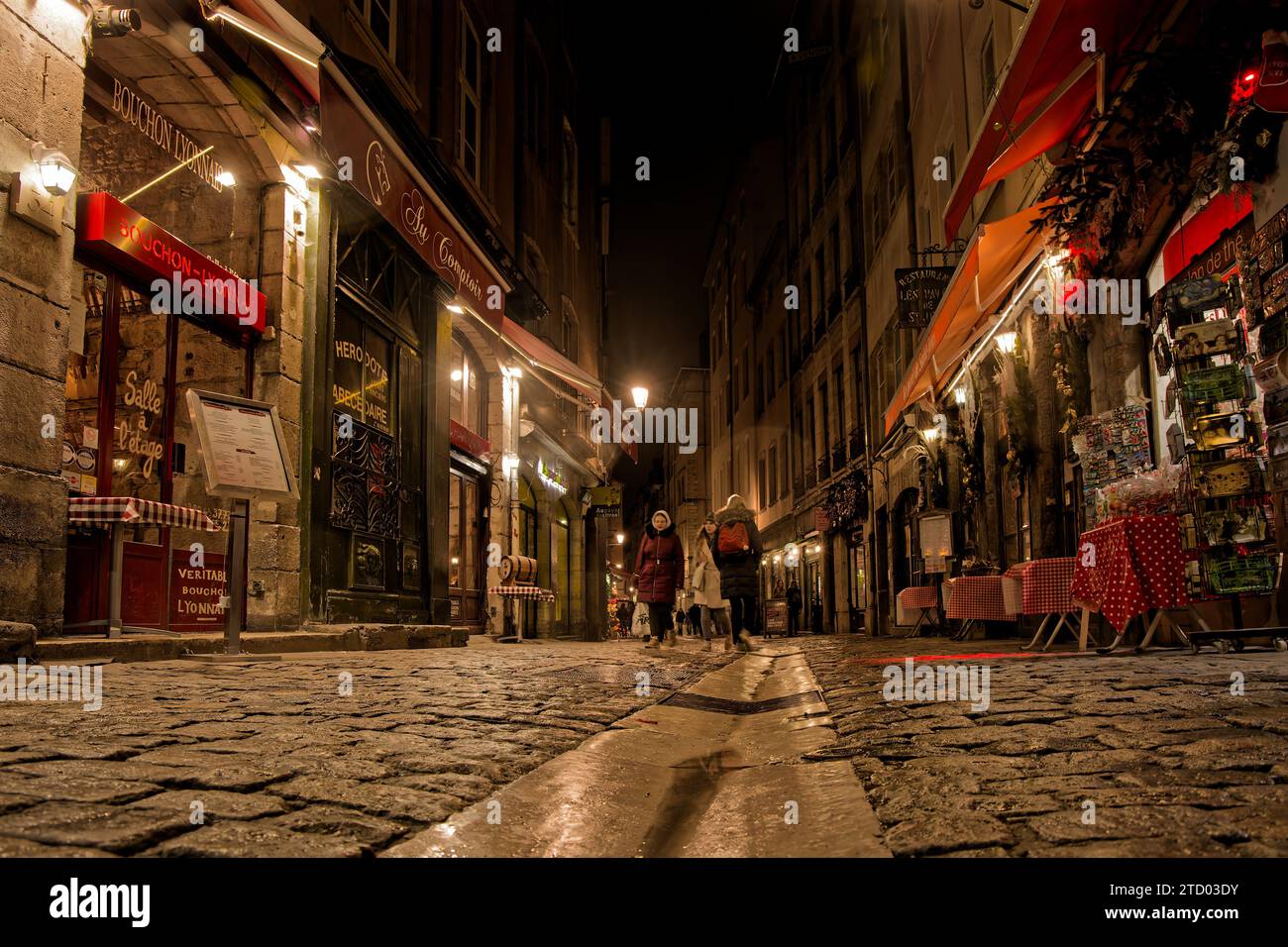 LYON, FRANCE, December 14, 2023 : Night on Rue Saint-Jean, a well-known street for its numerous bouchons lyonnais, traditional restaurants of the city Stock Photo