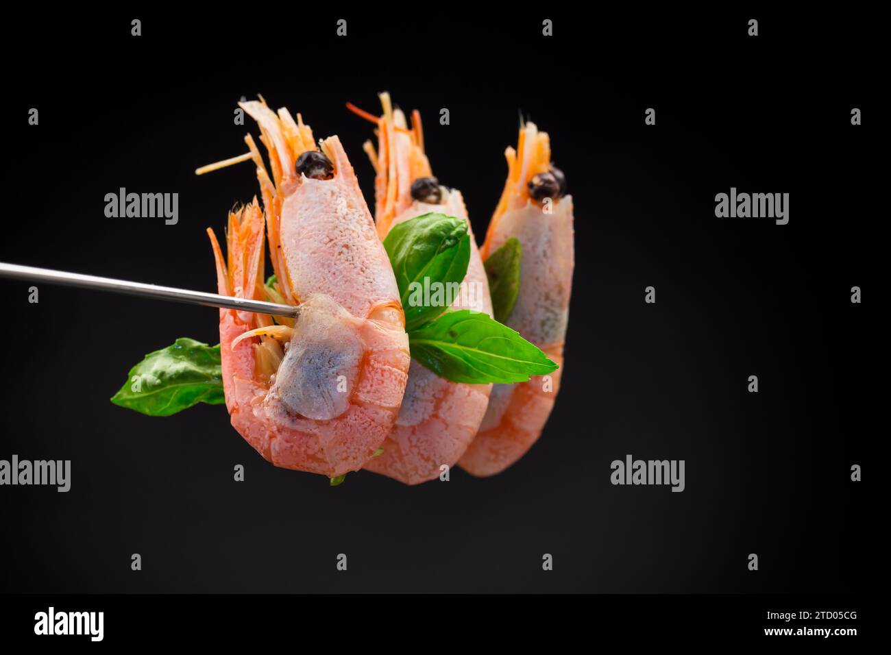 boiled shrimp with spices isolated on black background Stock Photo