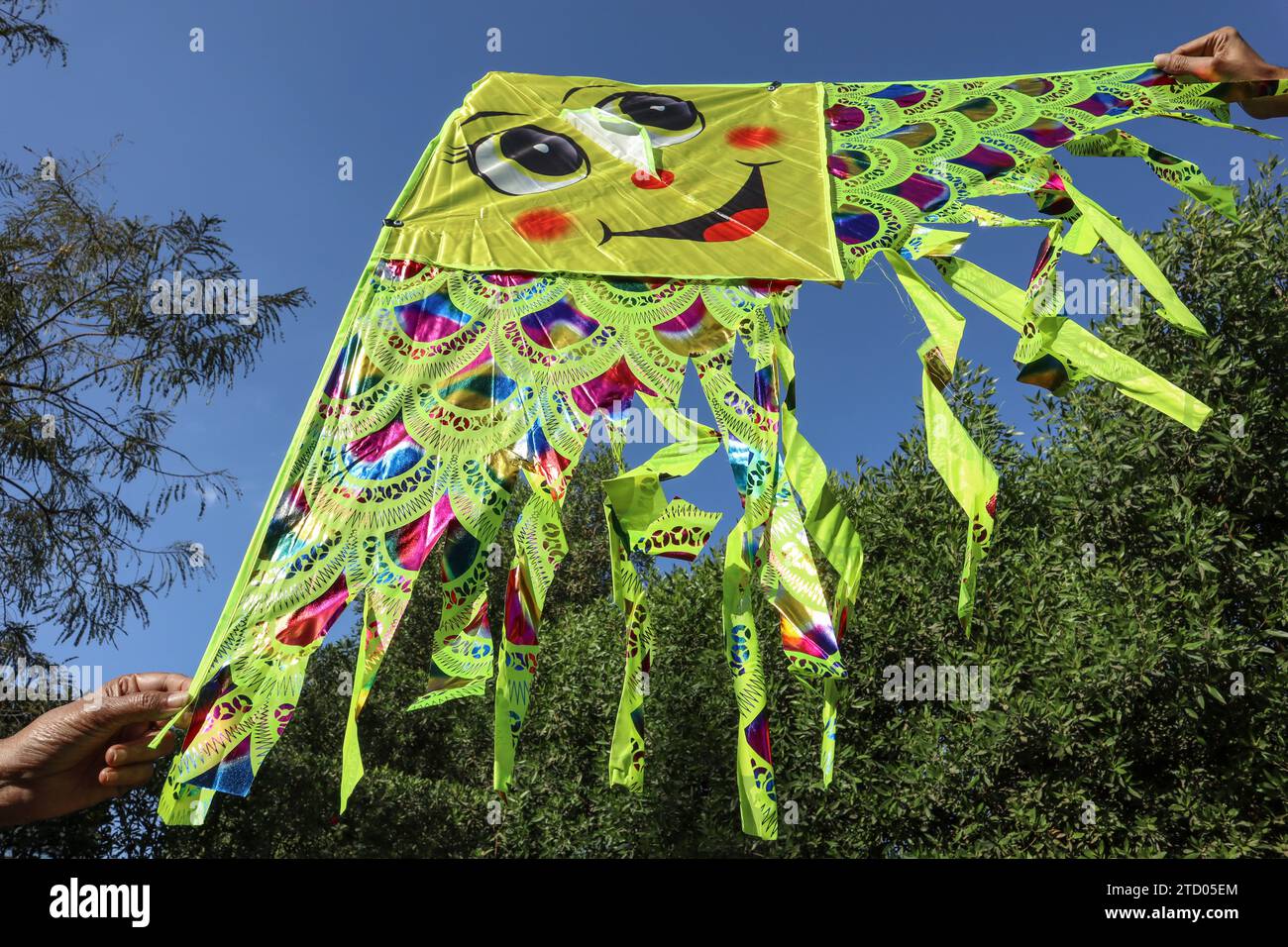 Cute and Big kite with amiley emoji flying. Foldable kite made of kite