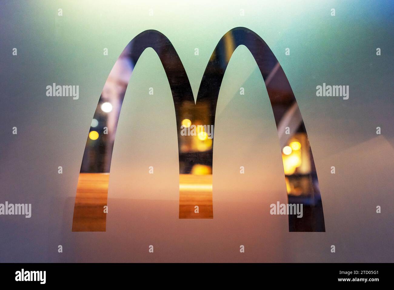 McDonald's logo on the glass of a restaurant window. Minsk, Belarus - January 14, 2023 Stock Photo