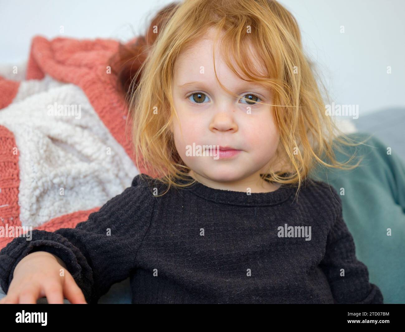 Innocent child in sweater looking directly at camera Stock Photo