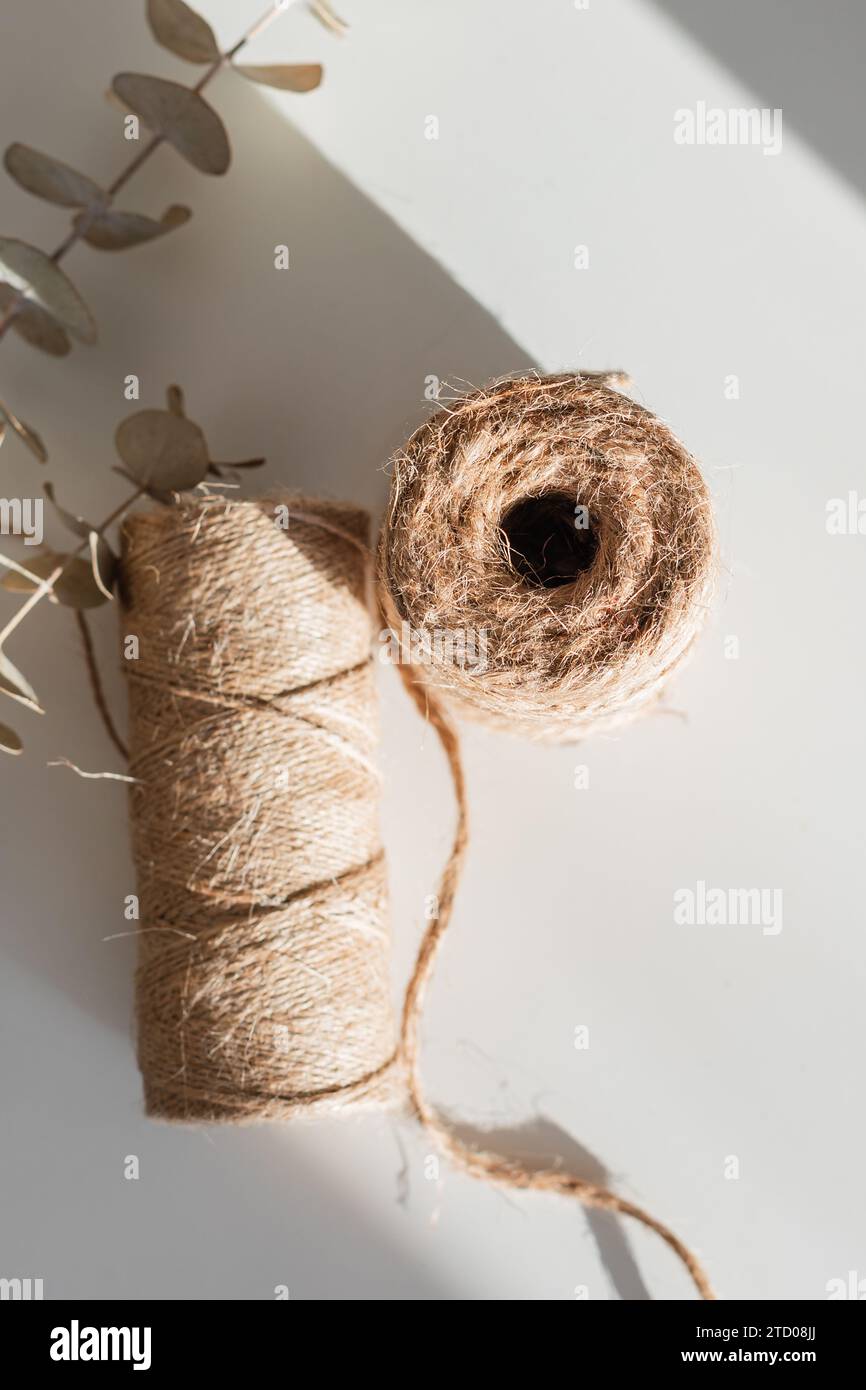 Roll of Twine in the sunlight with eucalyptus Stock Photo