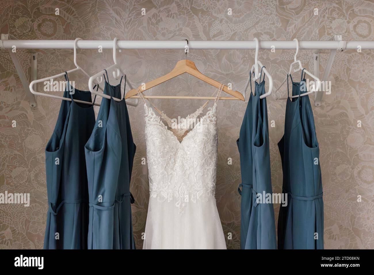 wedding Dress hanging in closet with blue bridesmaids dresses Stock ...