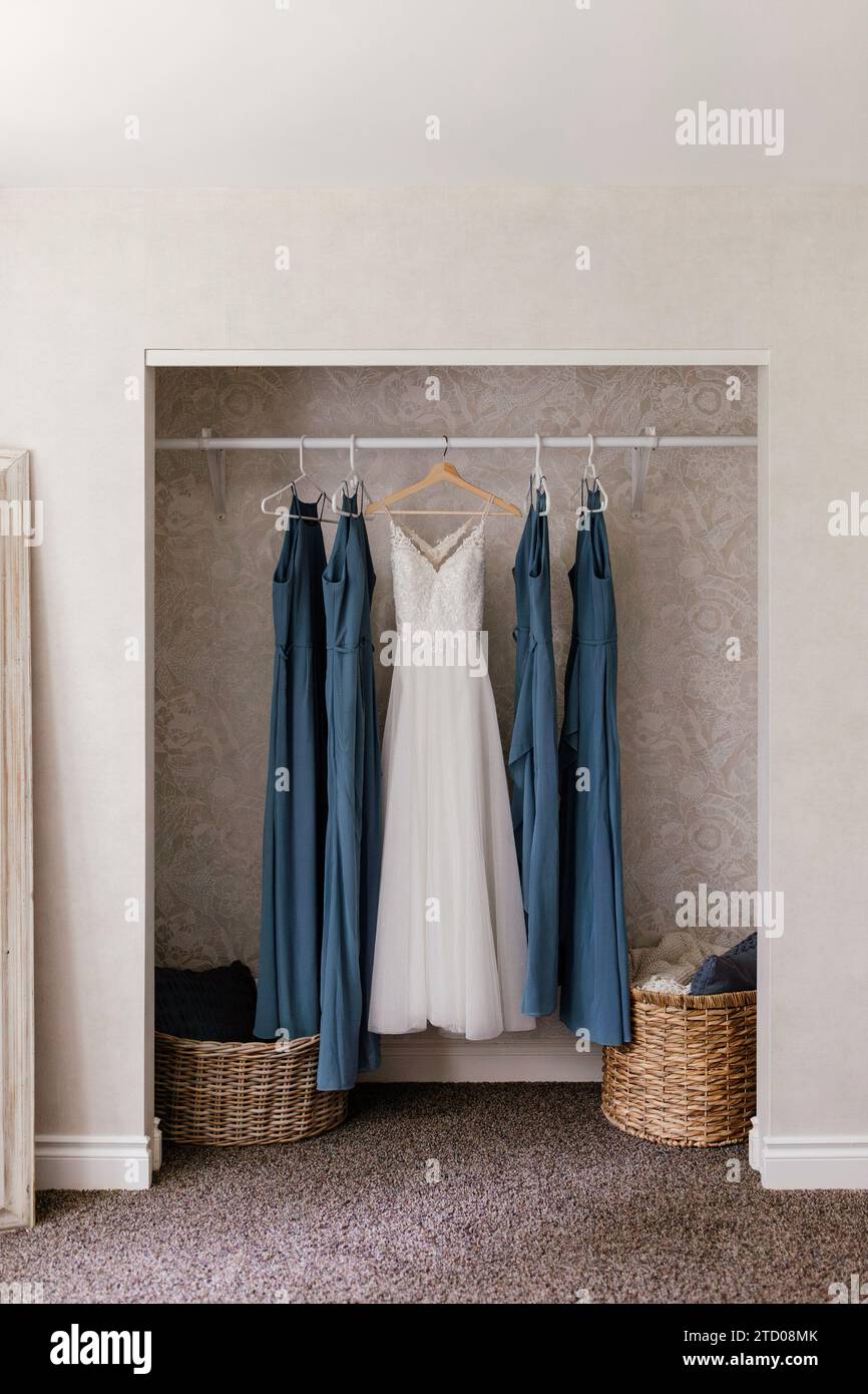 A-Line wedding dress hanging with blue bridesmaids dresses Stock Photo ...