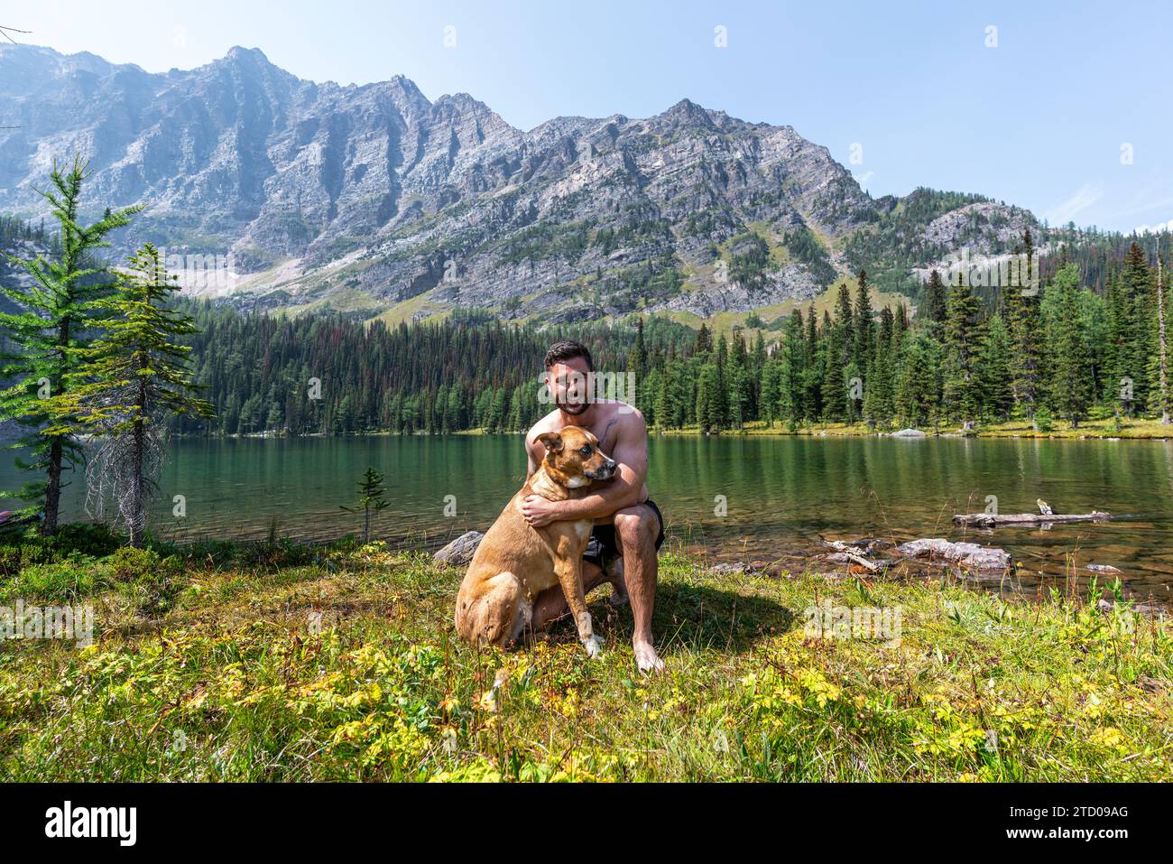Alpine Lakeside adventures With Man's Best Friend Stock Photo