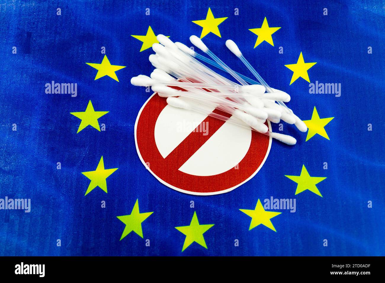 Plastic cotton swabs on European flag with prohibition sign, ban on