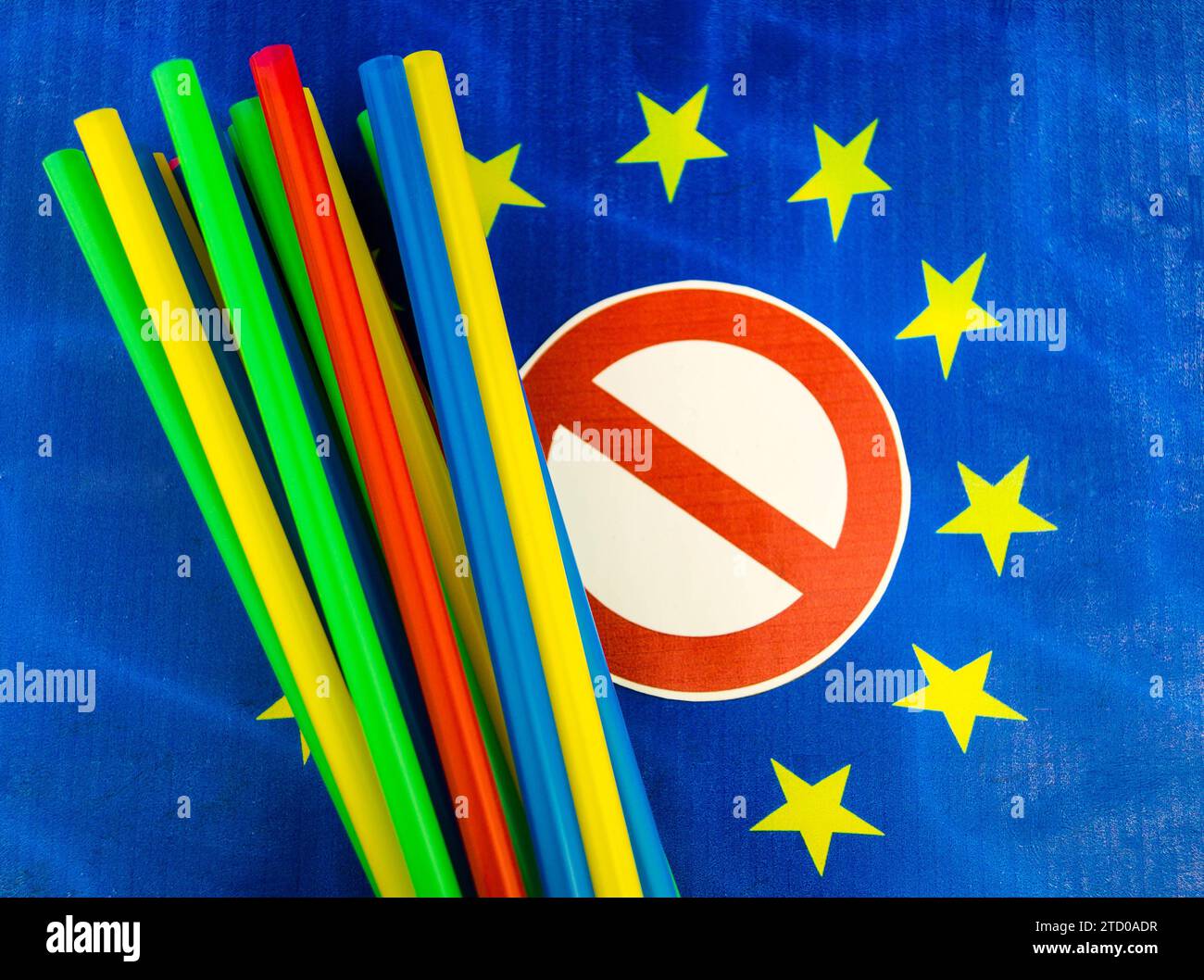 Plastic straws on European flag with prohibition sign, ban on plastic