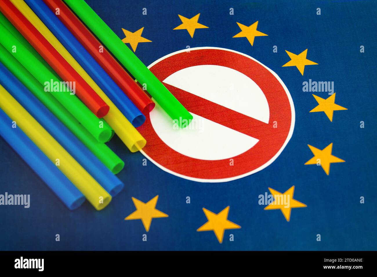 Plastic straws on European flag with prohibition sign, ban on plastic