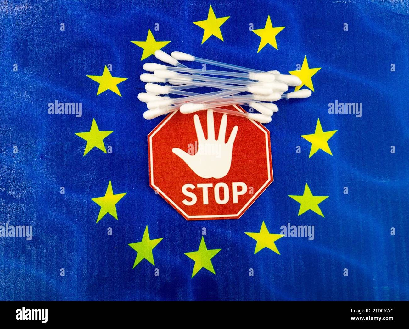 Plastic cotton swabs on European flag with stop sign, ban on plastic in