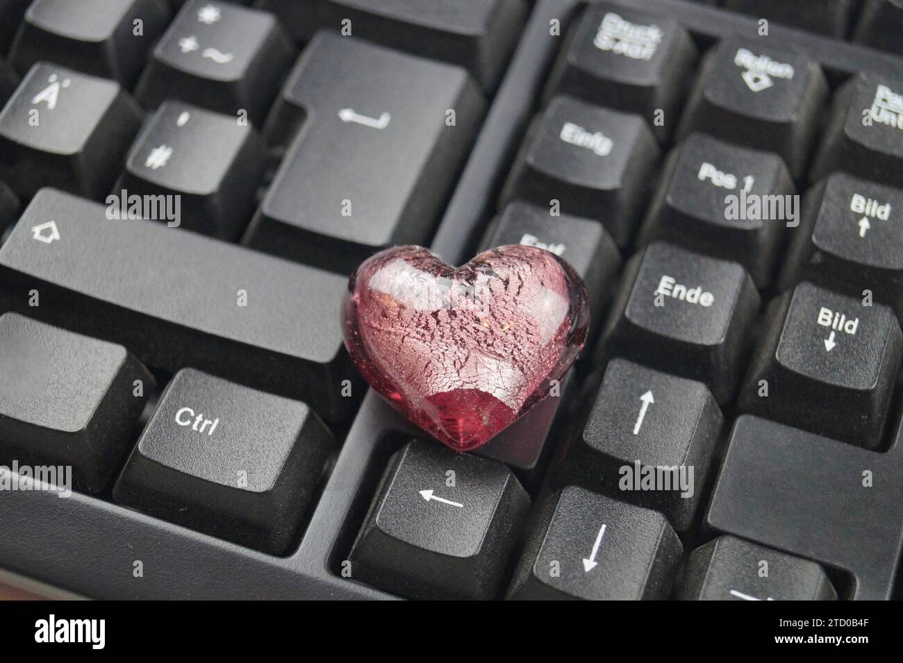 red heart on a computer keyboard, love online Stock Photo