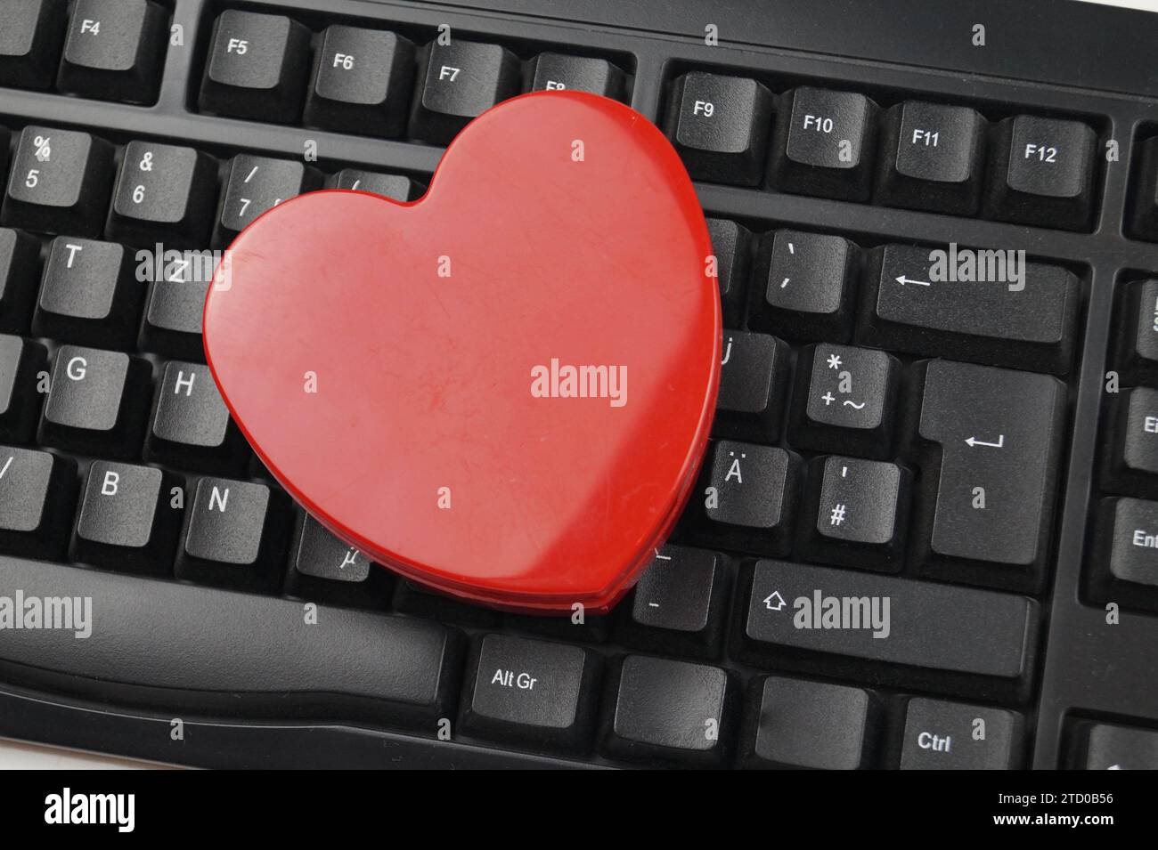 red heart on a computer keyboard, love online Stock Photo
