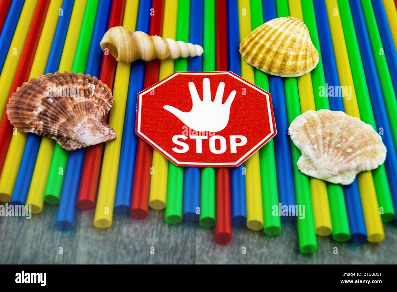 Plastic straws with stop sign, shells and snail shells from the sea