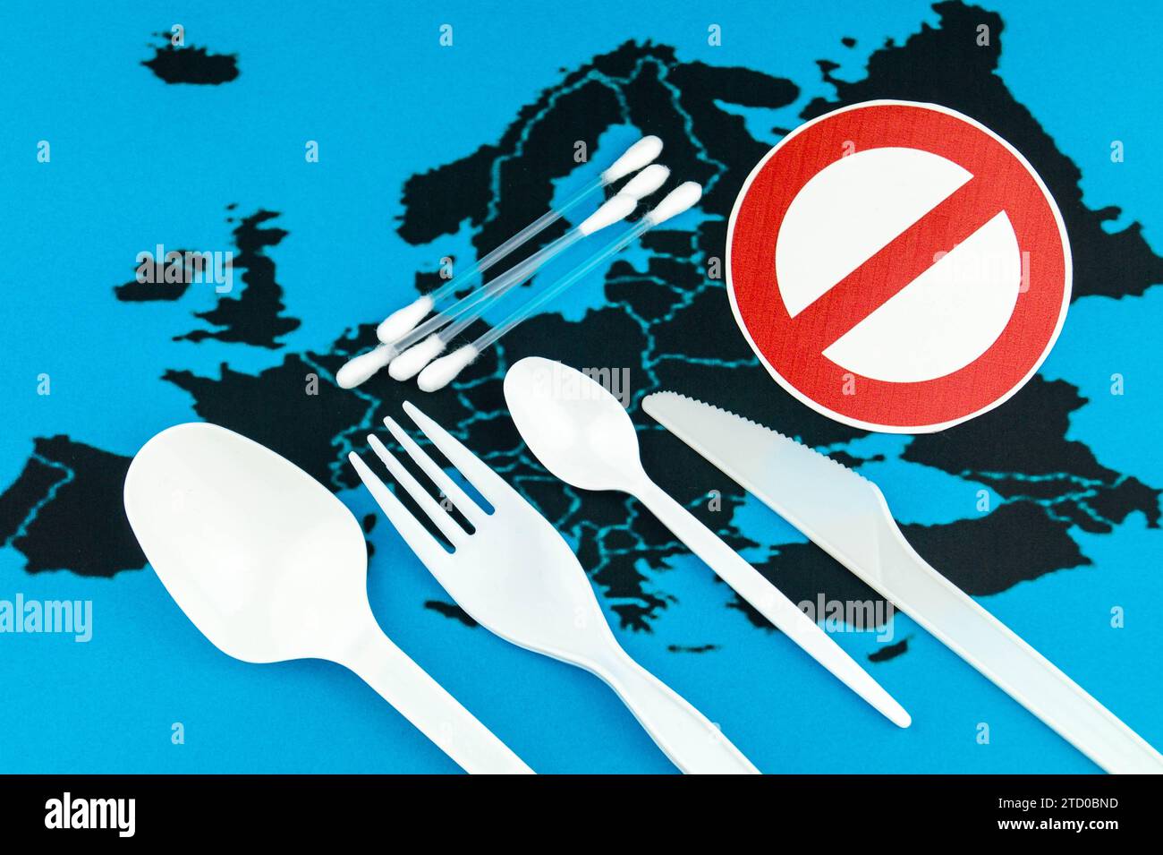 Plastic objects, cutlery and cotton buds on European map with
