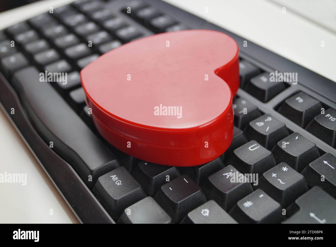 red heart on a computer keyboard, love online Stock Photo