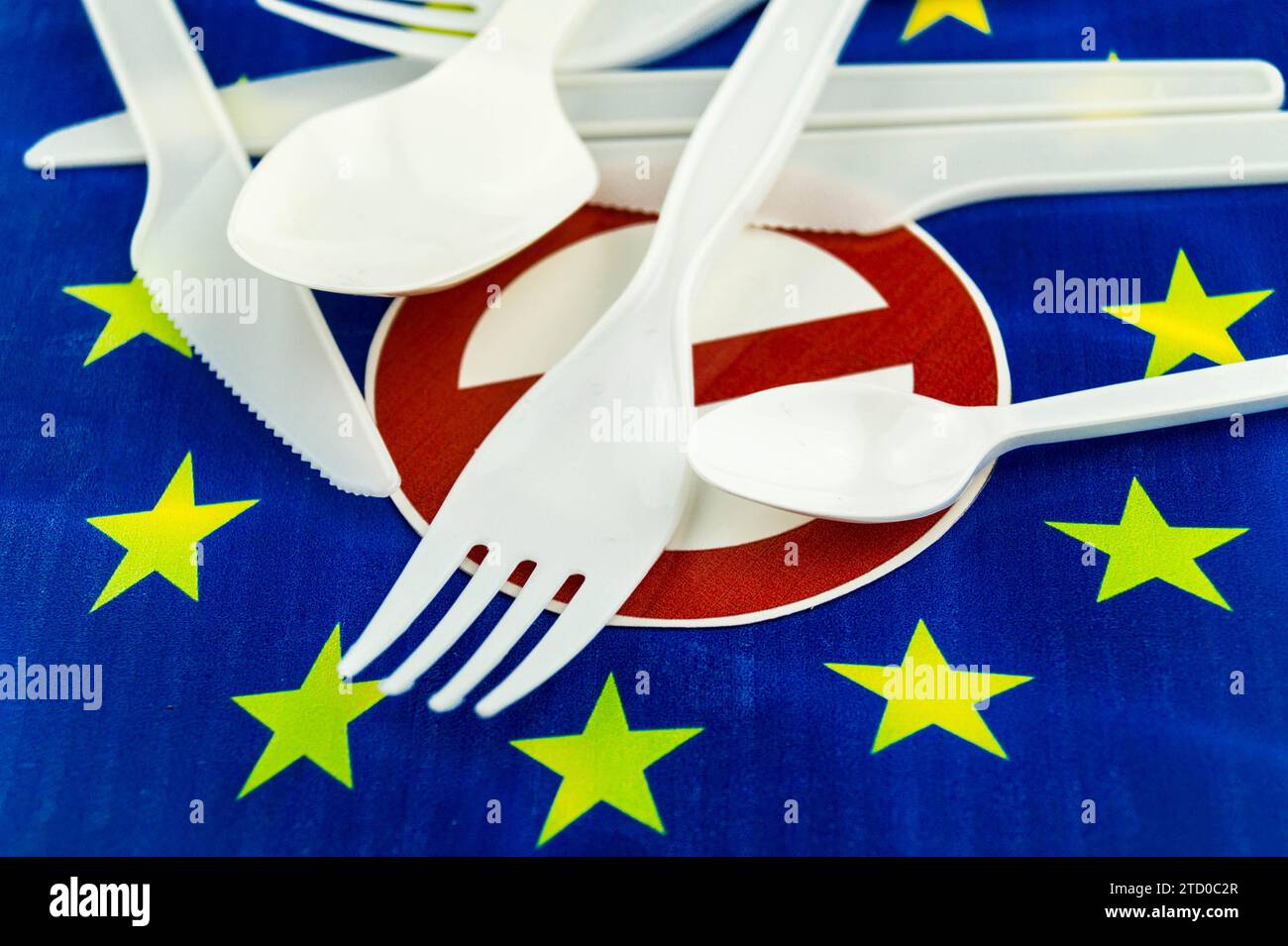 Plastic cutlery on European flag with prohibition sign, ban on plastic in the EU Stock Photo