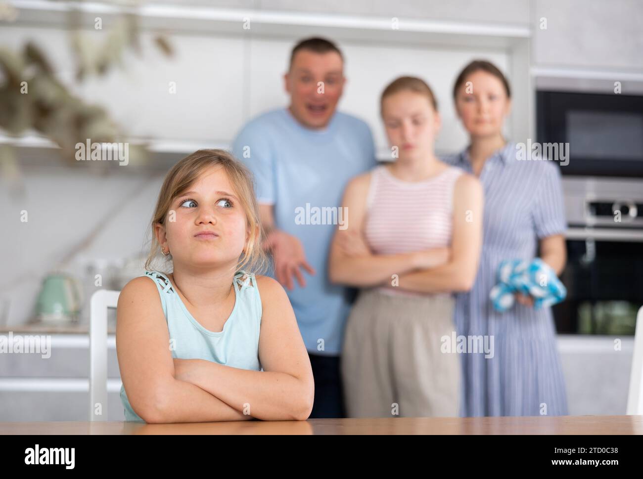Frustrated tween girl listening to disgruntled parents reprimand Stock ...