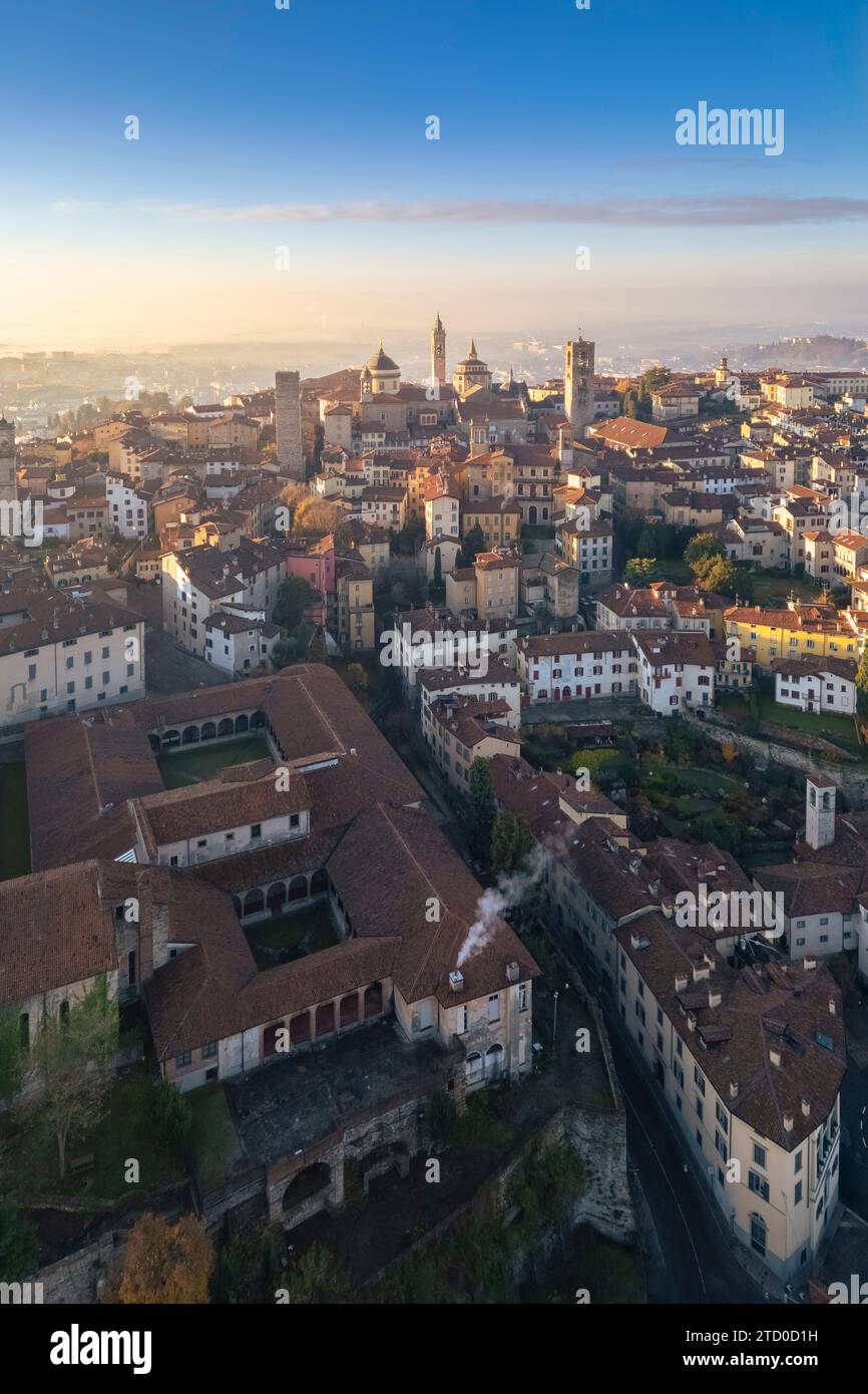 View of the rooftops, churches and towers of the Upper Town (Città Alta) of Bergamo city at sunrise. Bergamo, Lombardy, Italy. Stock Photo