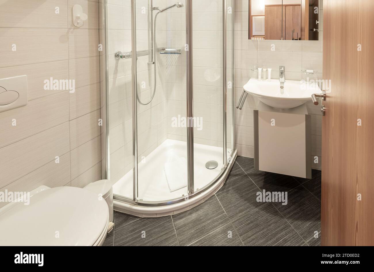 A clean, contemporary bathroom equipped with a corner shower enclosure — free download