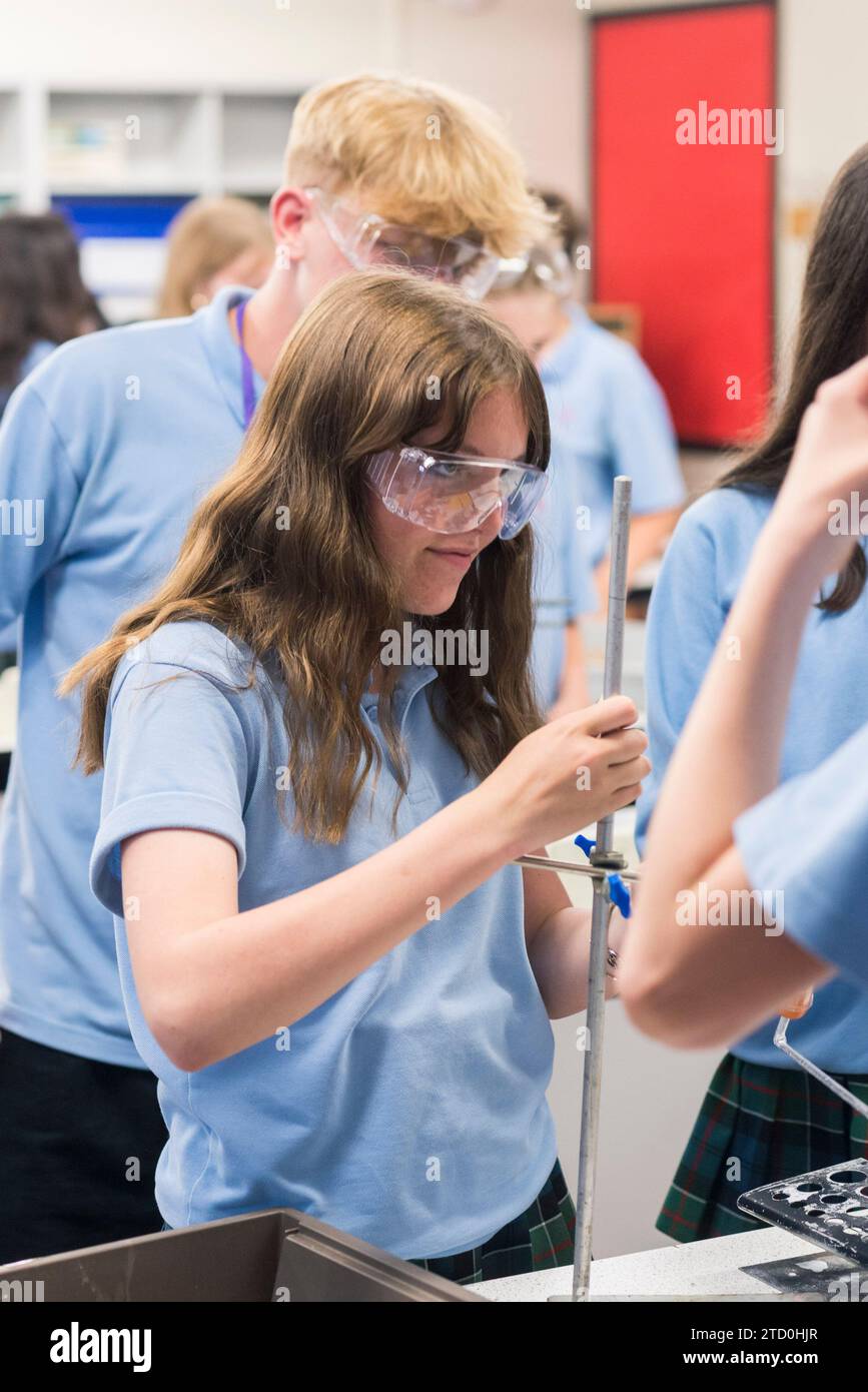 Students in a high school science lab carry out a practical science ...