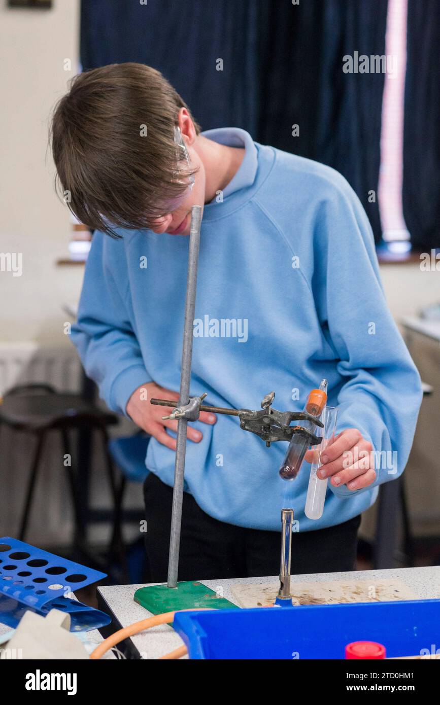 Students in a high school science lab carry out a practical science ...