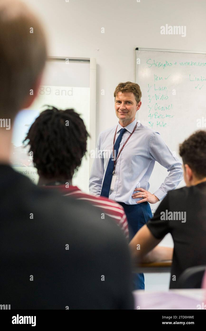 A teacher takes a lecture in a school class room. Stock Photo