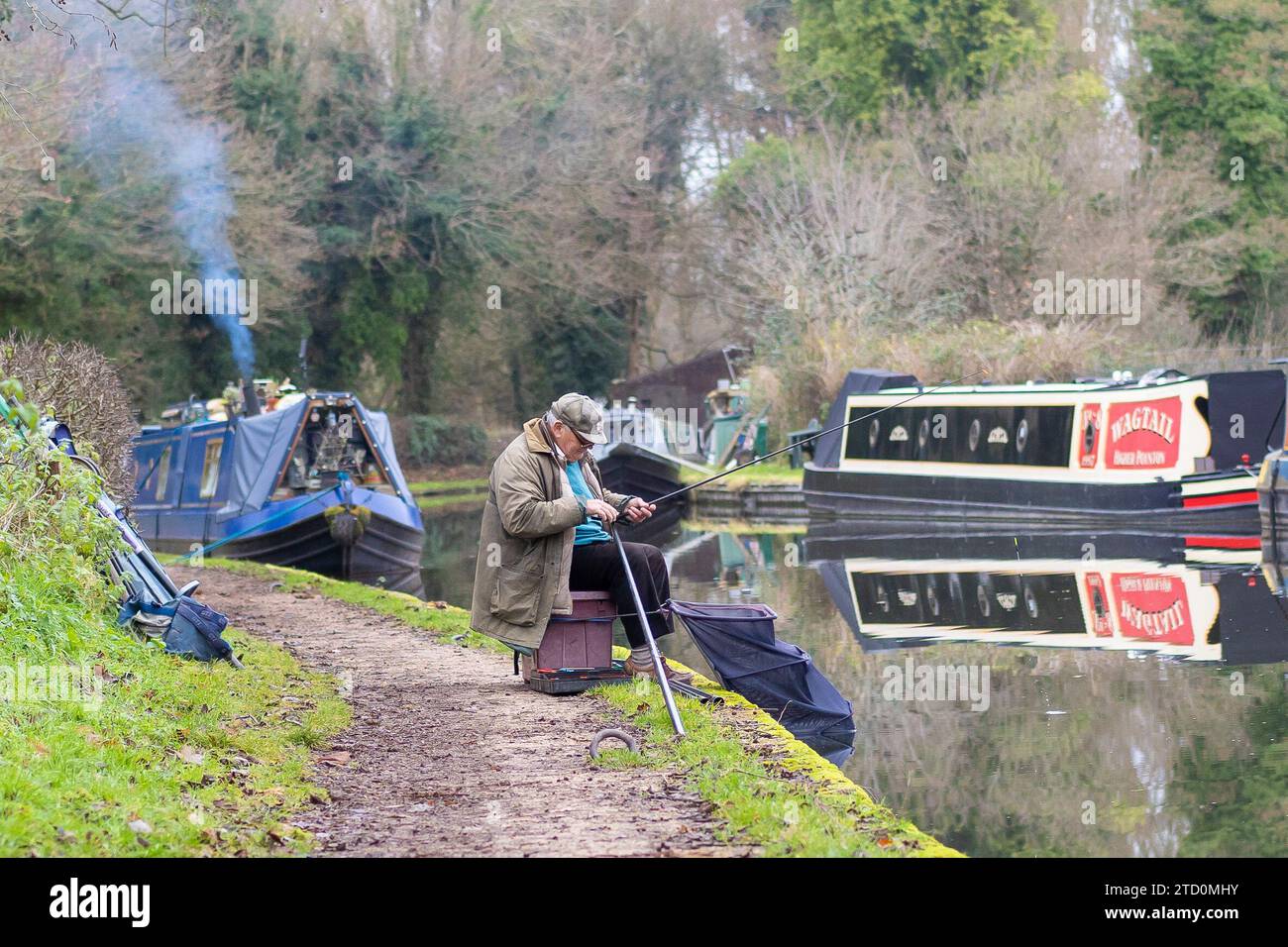 Stourbridge, UK. 15th December, 2023. UK weather: its a cool and dull morning in the Midlands but it doesn't stop people getting out and enjoying their favourite pastime. This gentleman sets up his fishing gear for a quiet morning of fishing on the canal, away from the hustle and bustle of Christmas town shopping. Credit: Lee Hudson/Alamy Live News Stock Photo