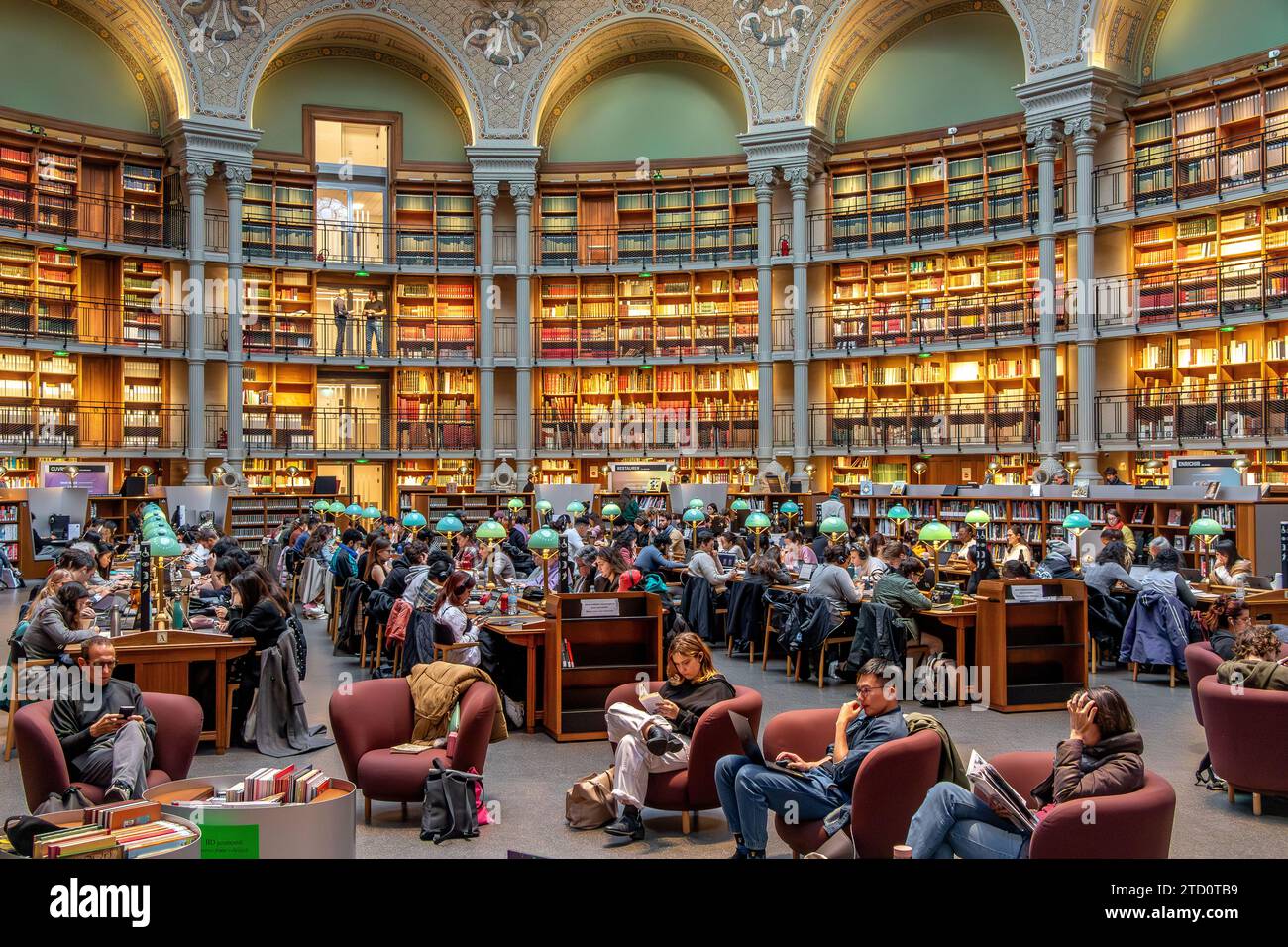 People reading and studying the books at The magnificent Oval reading