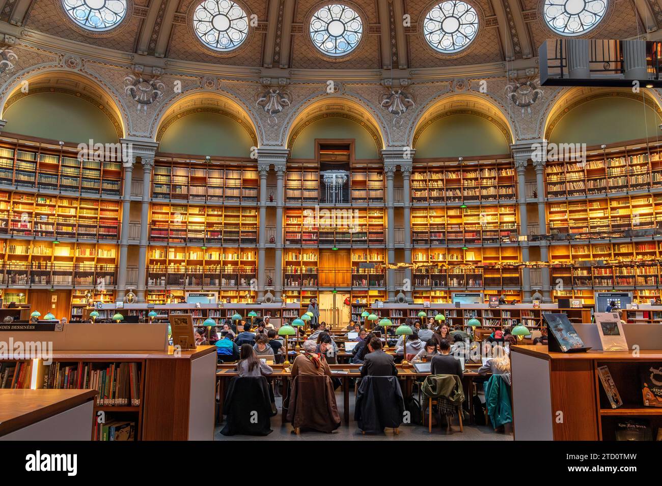 People reading and studying the books at The magnificent Oval reading