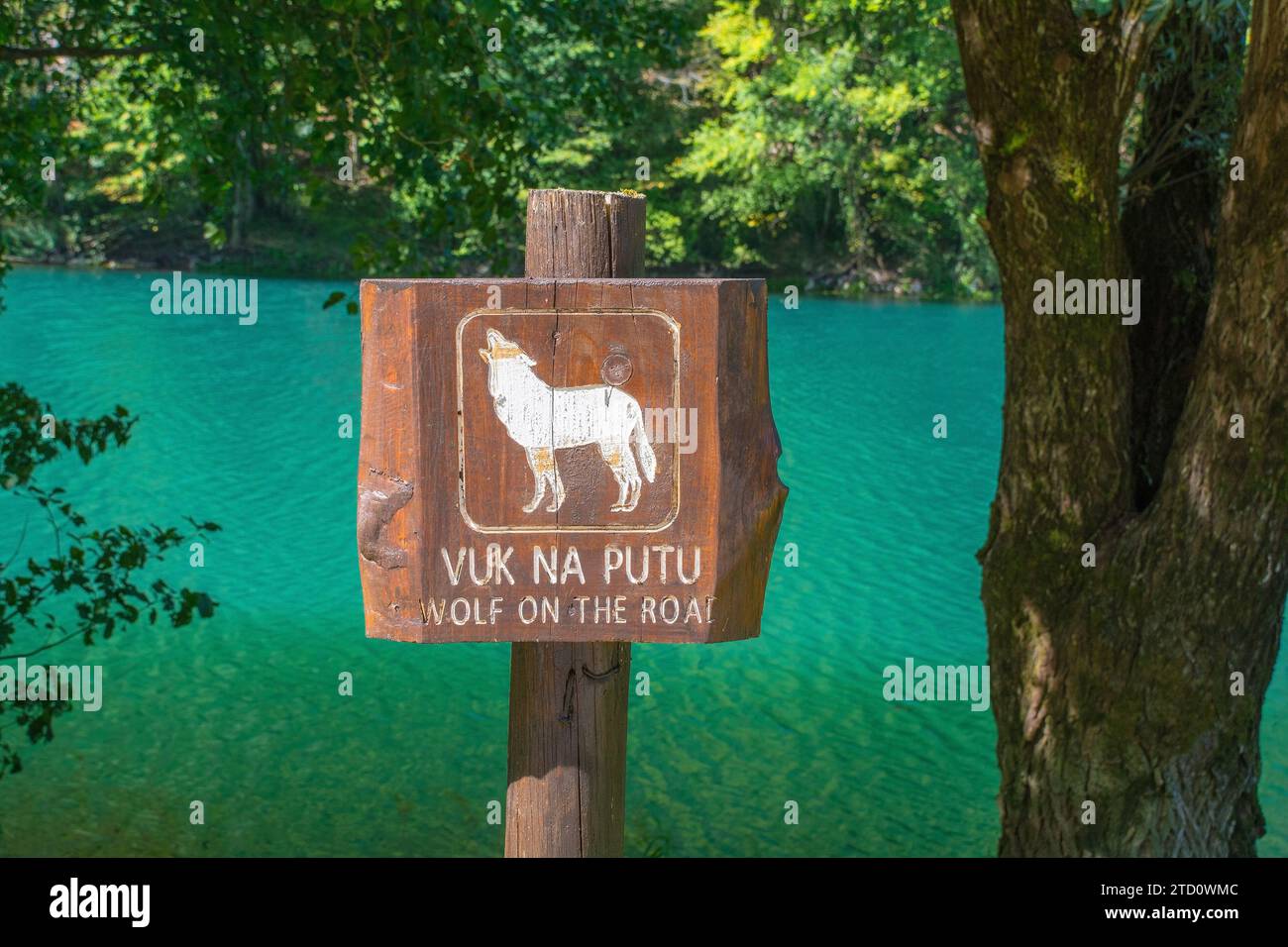 A sign informs visitors about the presence of wolves near Orasac, Bihac, in the Una National Park. The River Una is in the background. Una-Sana Canton Stock Photo