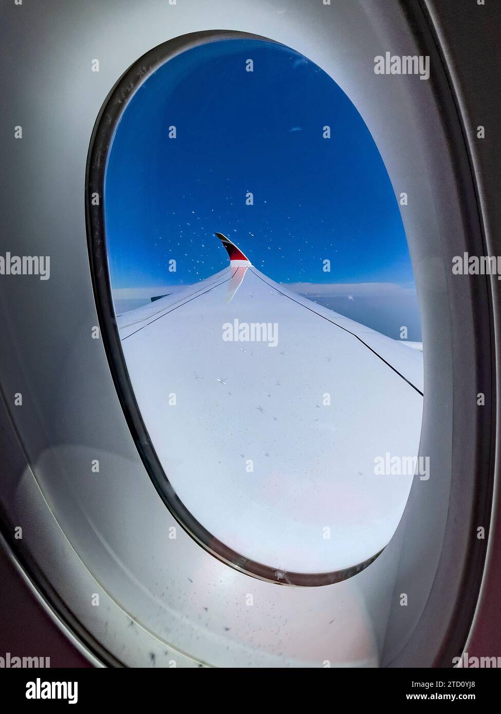 Madrid, Spain; May 31, 2023: Vertical photograph of the wing of an Airbus A350-900 of the Spanish airline Iberia, flying above the clouds and under a Stock Photo