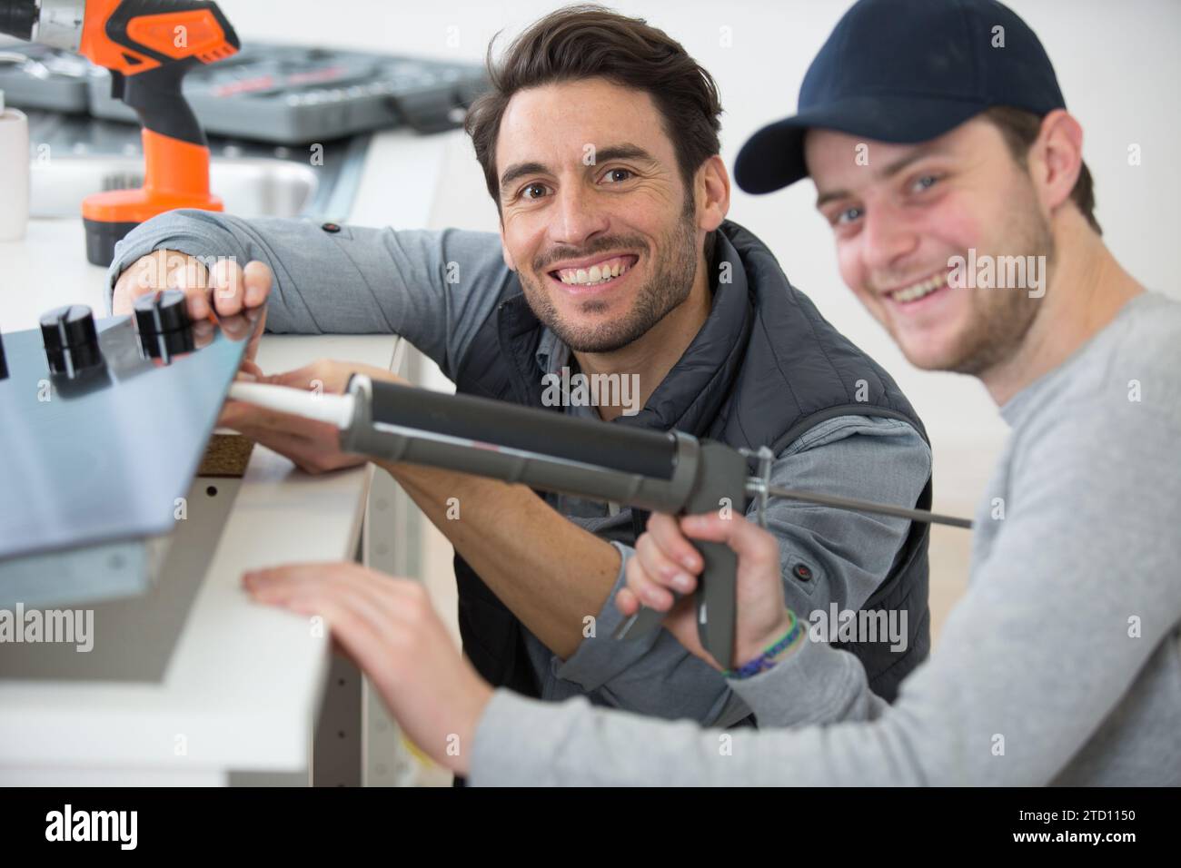 man using a silicone tube with apprentice Stock Photo