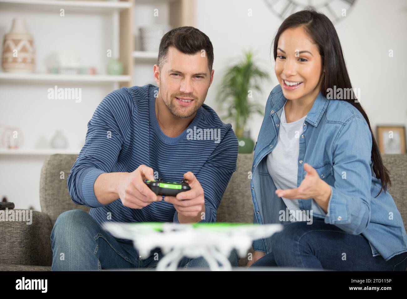 happy couple using modern drone Stock Photo