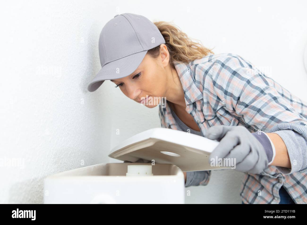 young woman checking and cleaning air conditioning Stock Photo