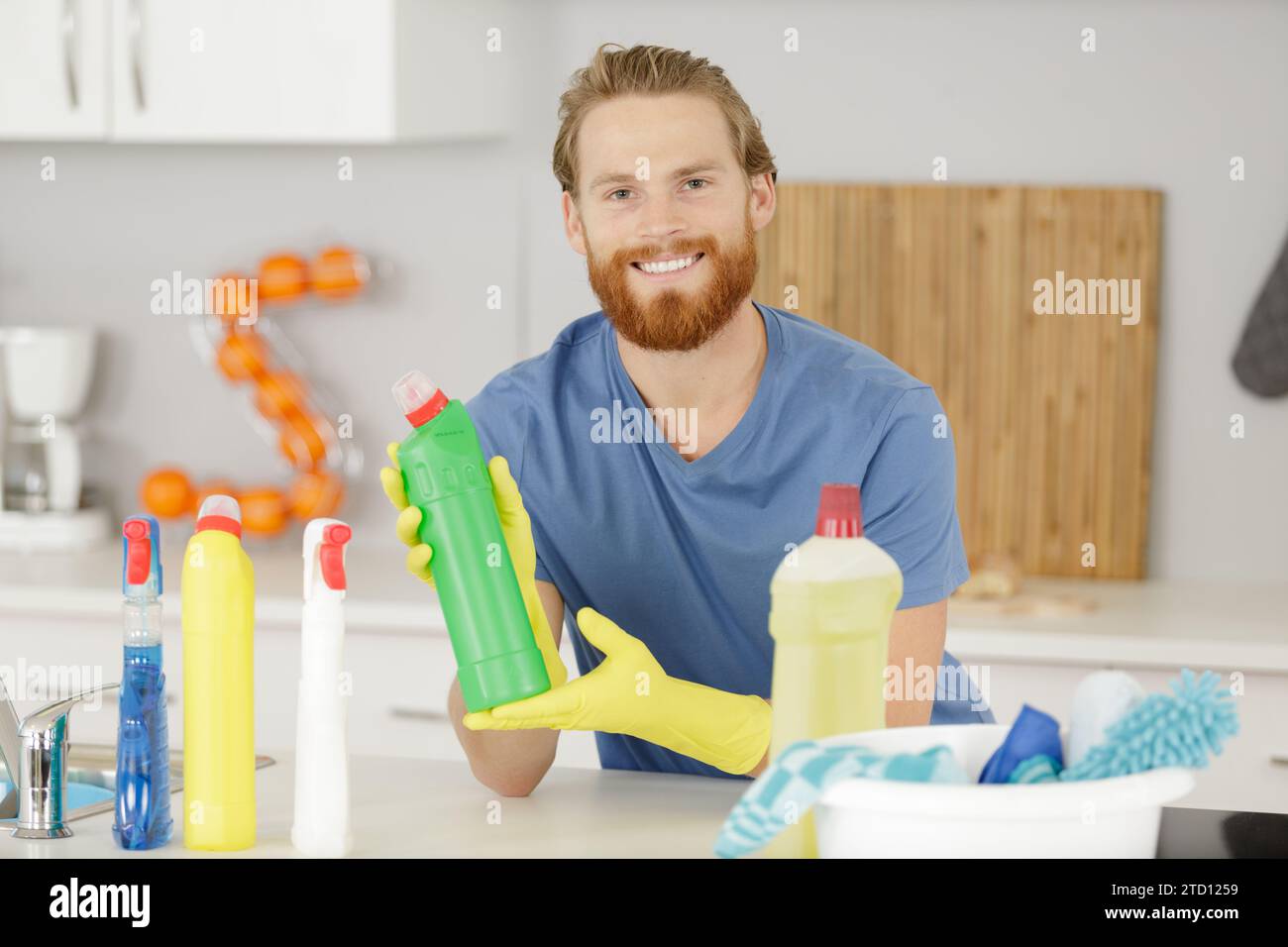 happy man cleans with cleaning products Stock Photo Alamy
