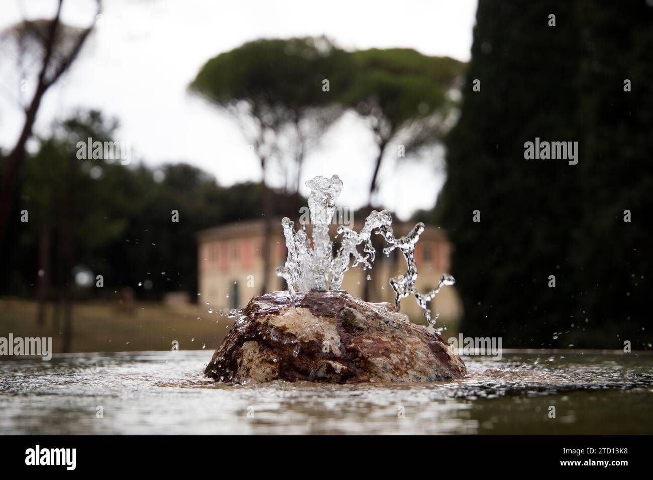 Drinking water fountain Fountain of the Puppets at Villa Borghese with a view of La Casina di Raffaello Stock Photo