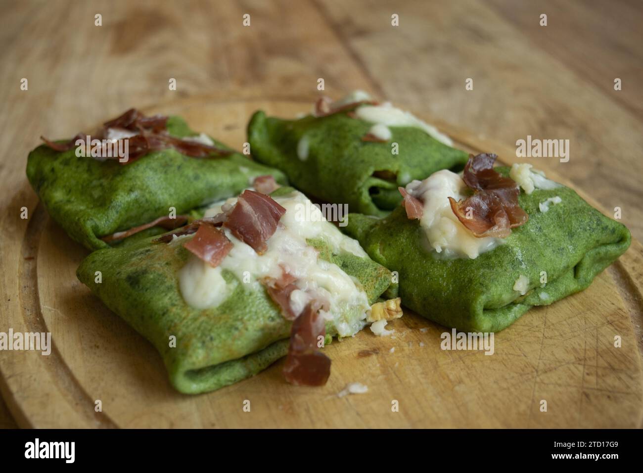 spinach crepes with roasted speck and parmesan cream Stock Photo