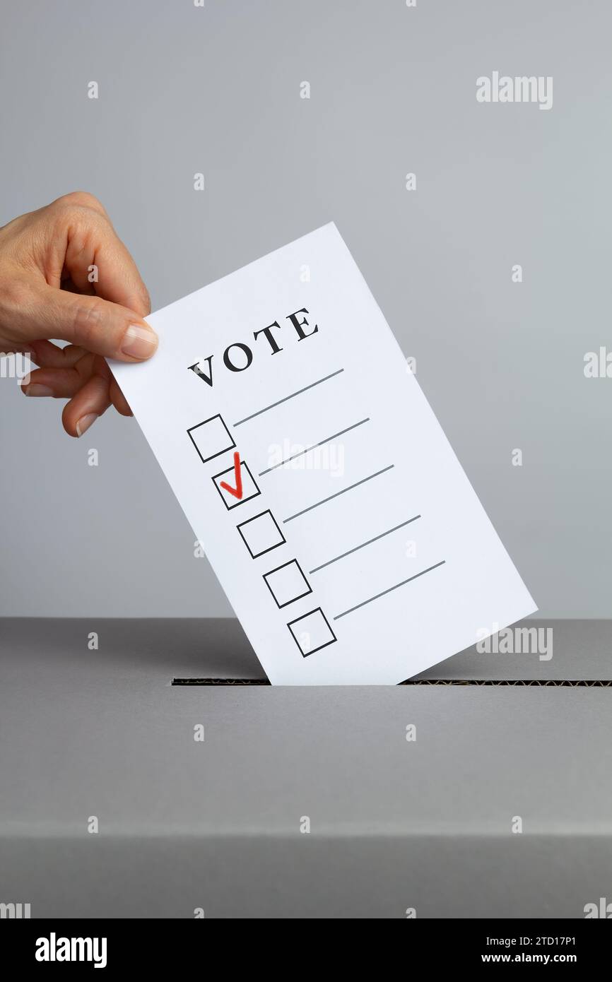 Hand throws ballot paper into ballot box hi-res stock photography and ...