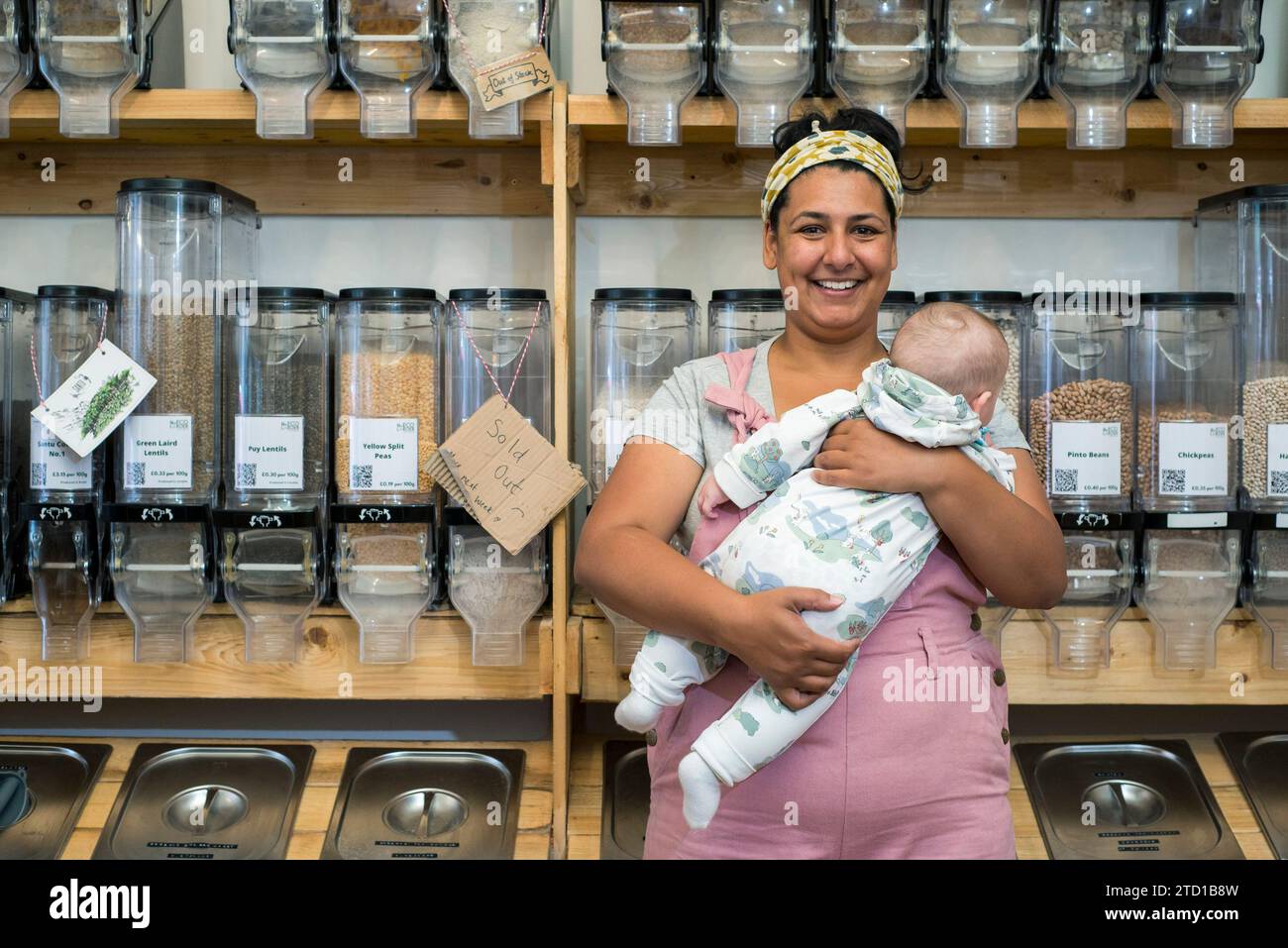 A young woman and business owner stands in her environmentally friendly natural food and drink shop. Stock Photo