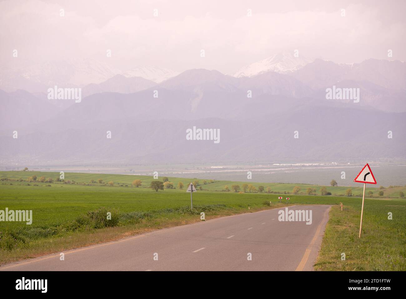 Road in green fields. Ivanovka village. Ismayilli region. Azerbaijan. Stock Photo