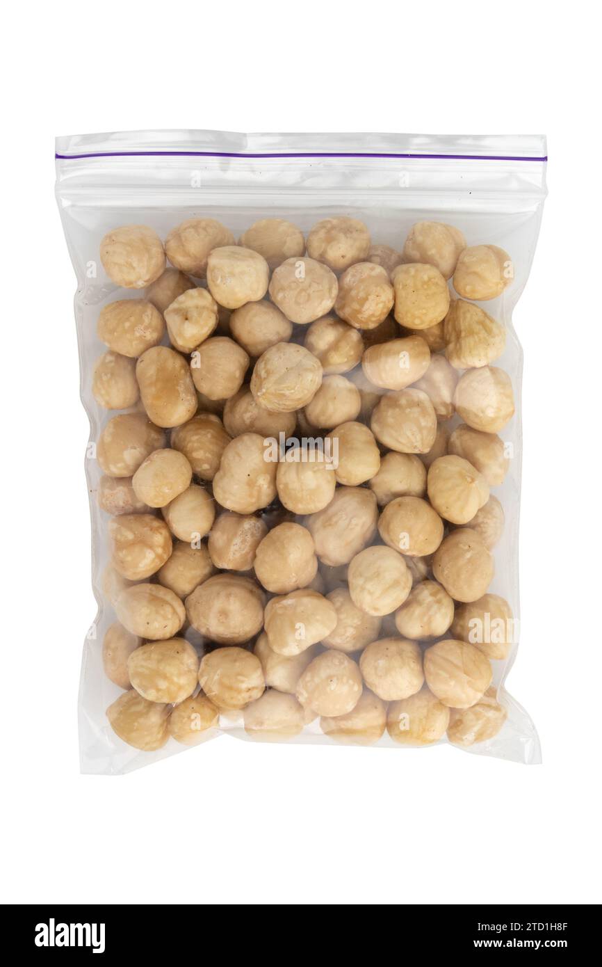 heap of roasted peeled hazelnuts isolated on white background, top view ...