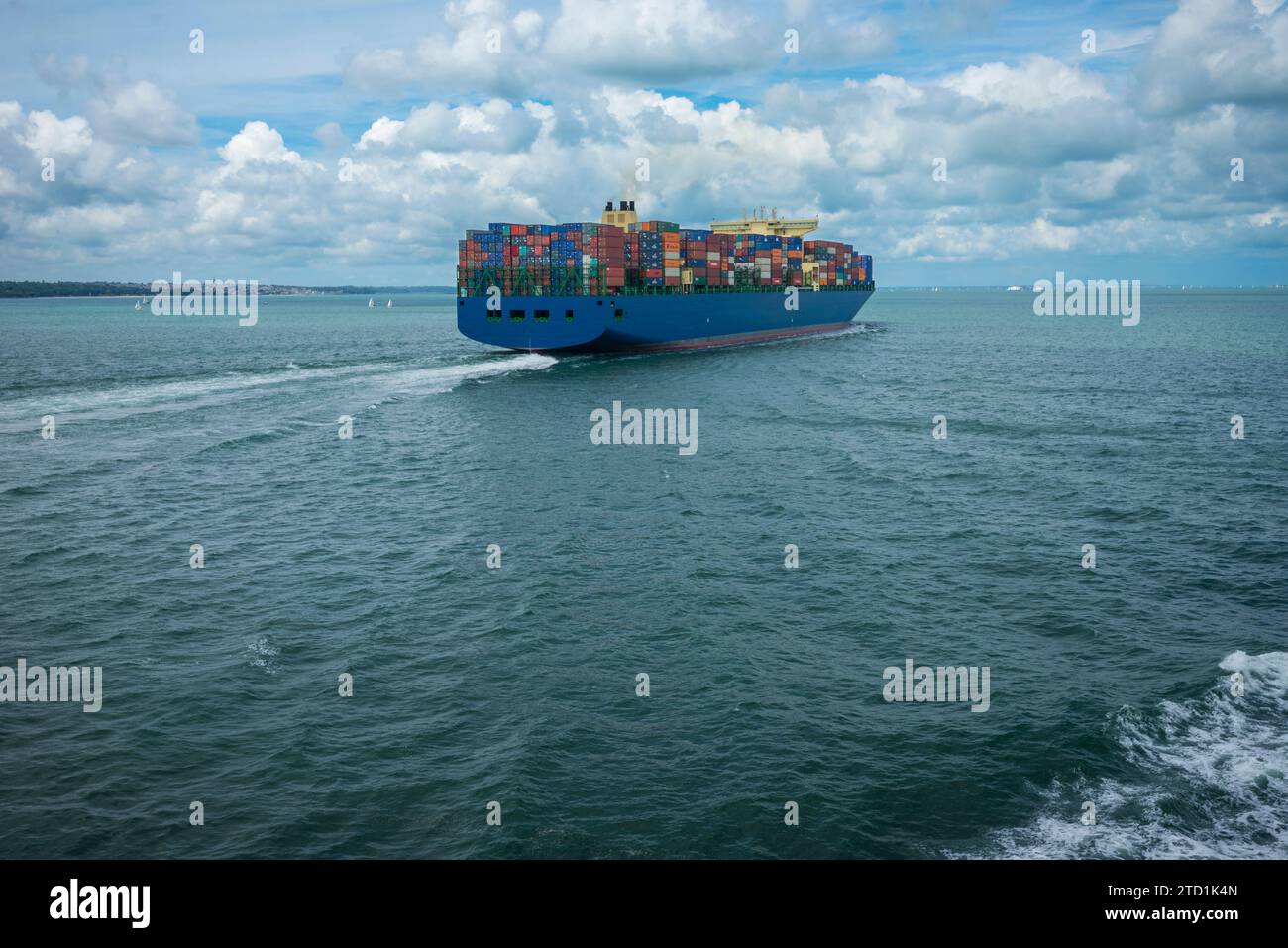 A container ship full with metal containers sails out of Portsmouth harbour in England in the UK Stock Photo