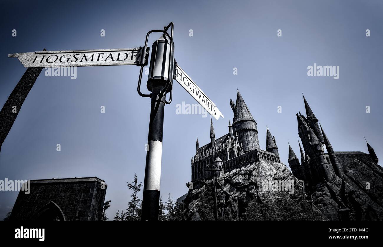 Hogsmeade and Hogwarts Sign pointing to the Castle at the Wizarding World of Harry Potter in Universal Studios Hollywood - Los Angeles, California Stock Photo