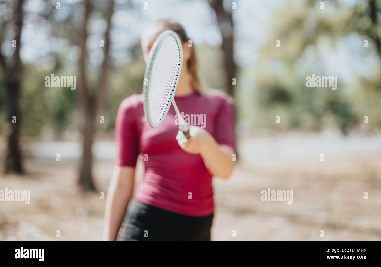 Sports girl posing with racket, showcasing her healthy lifestyle and ...