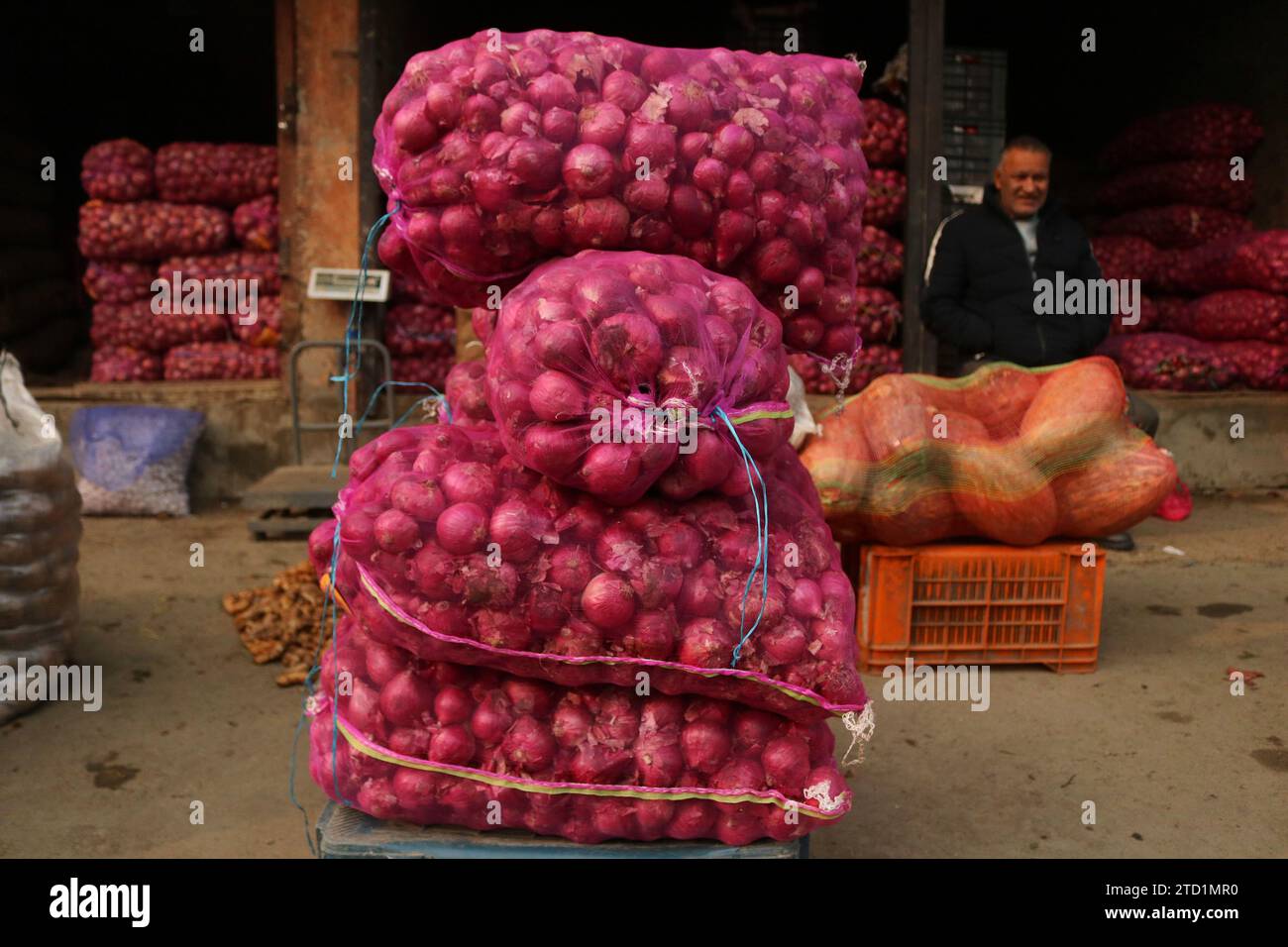 December 15,2023, Srinagar Kashmir, India A vendor arranges onions at