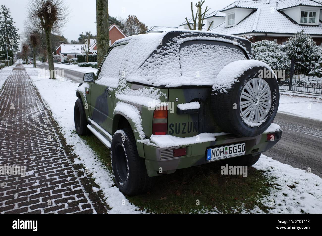 Itterbeck, Germany December 4 2023 An army green Suzuki Vitara with a layer of snow. It's a first generation Vitara made between 1988 and 1998 Stock Photo