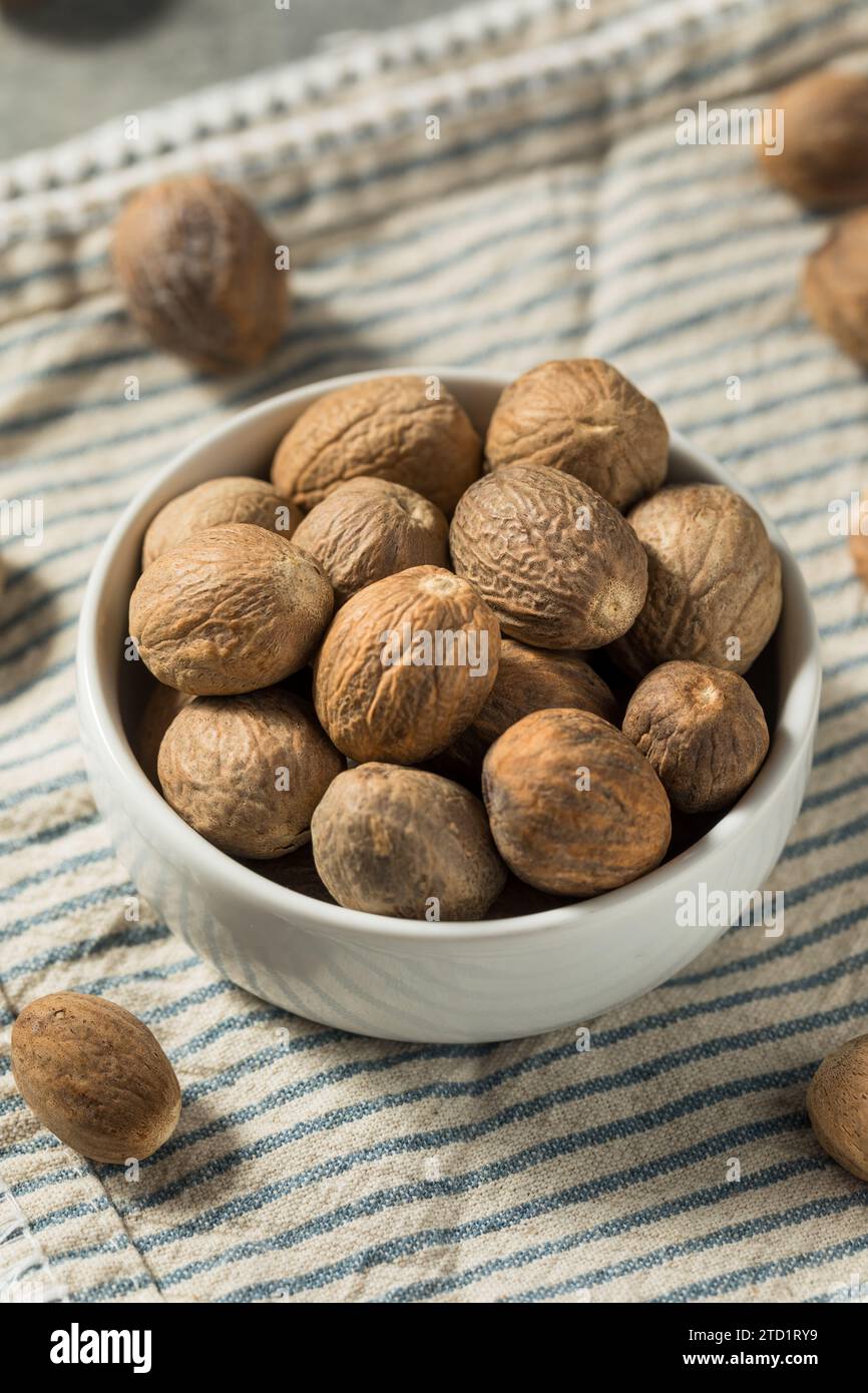 Organic Dry Whole Nutmeg in a Bowl Stock Photo - Alamy